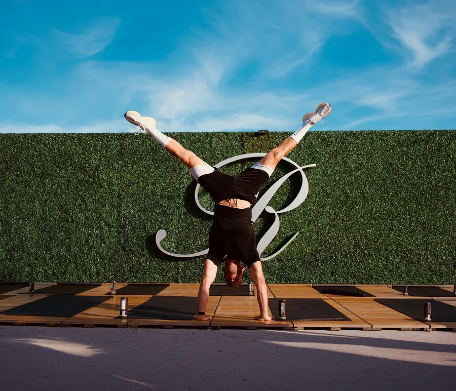 The Pilates instructor performing a handstand