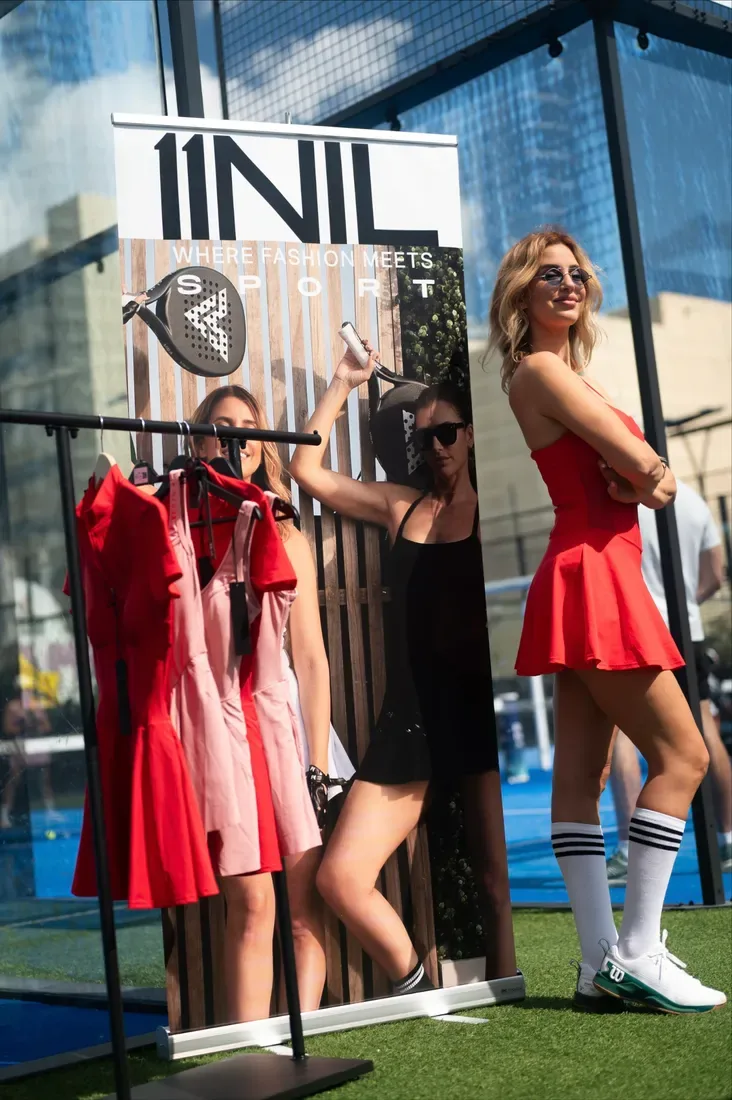 A player beside a fashion and sport brand display