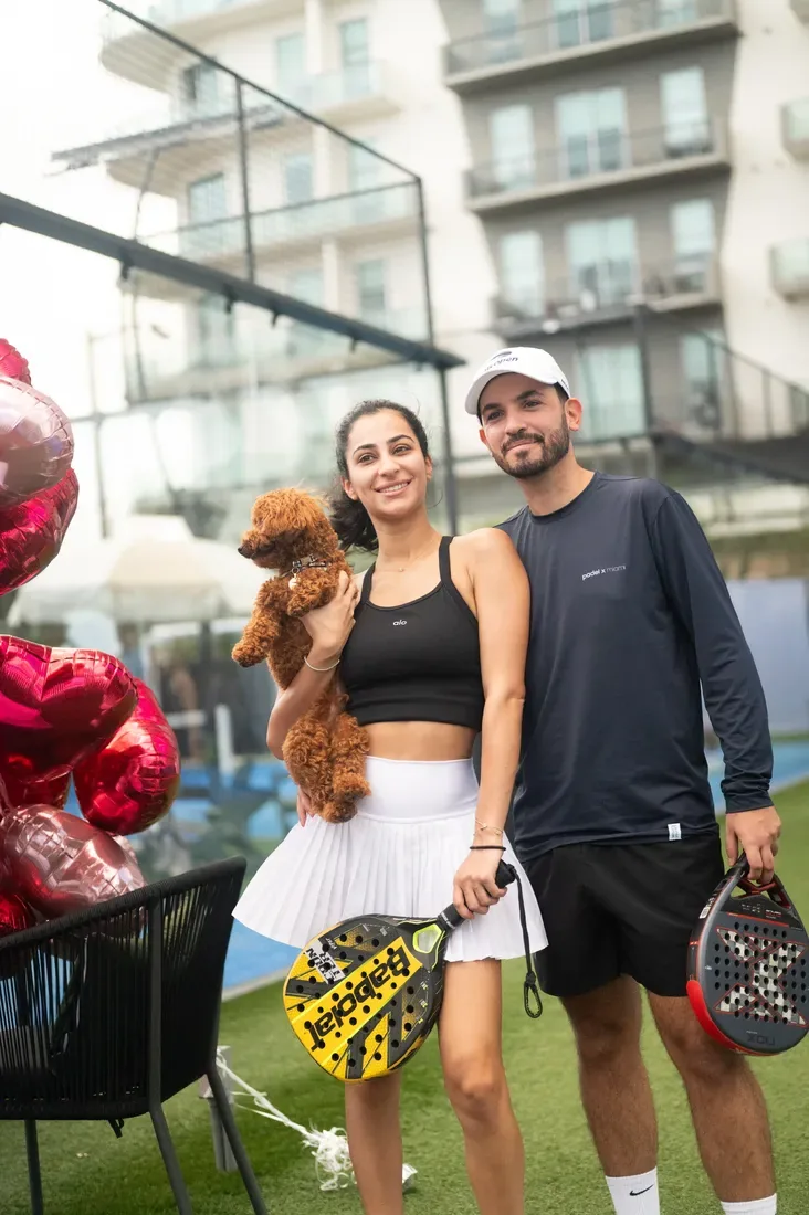 A couple with their dog beside the court