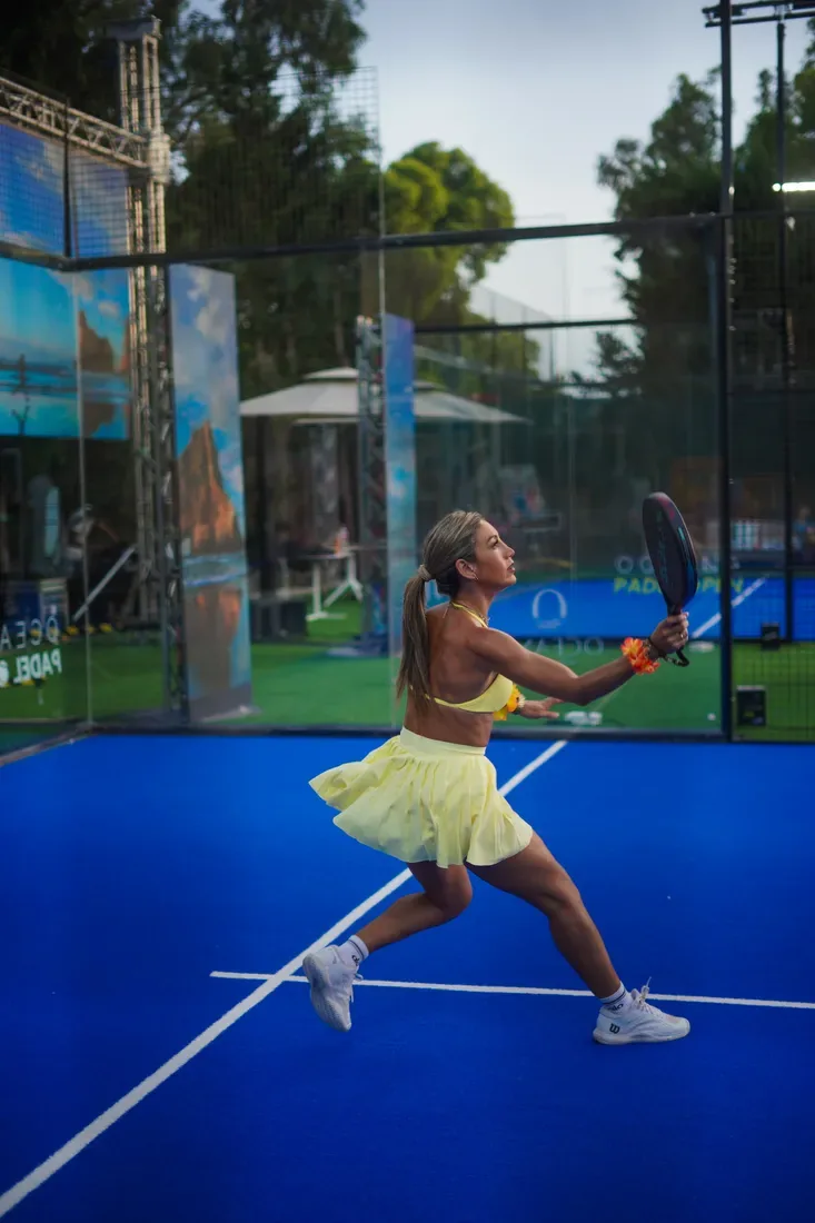 A player in yellow striking the ball at Aloha