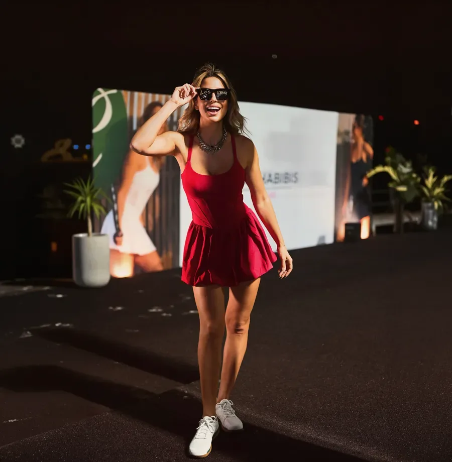 A guest in red wearing Los Habibis sunglasses